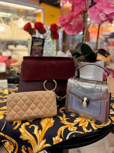 A selection of pre-owned designer handbags displayed inside Sassy Sisters